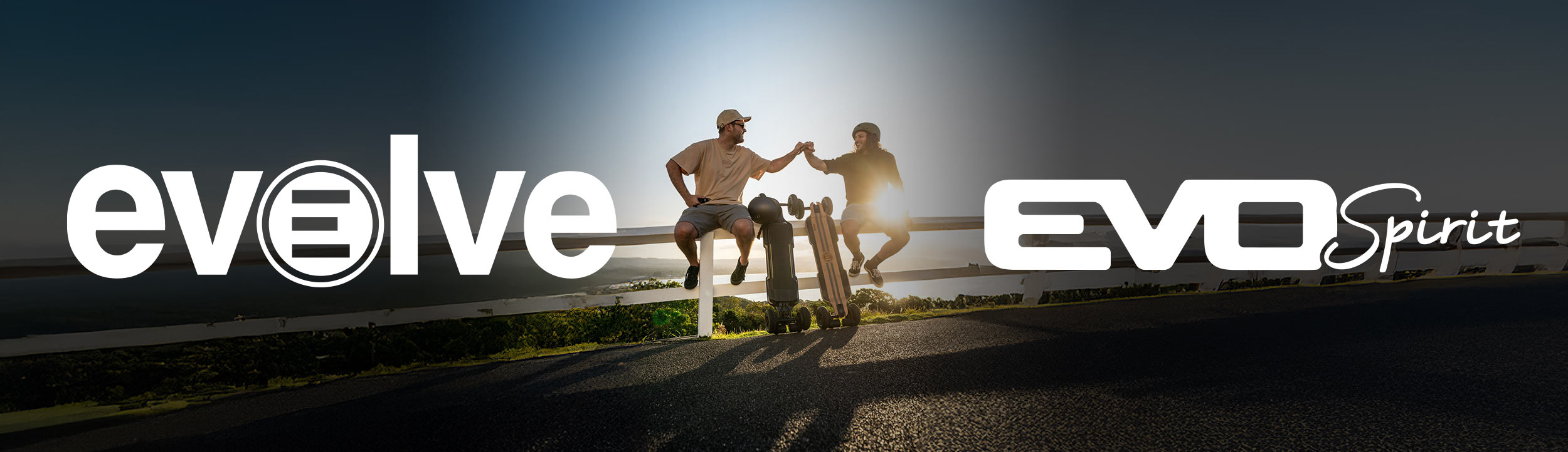 Photo of two riders sitting with their electric boards and Evolve and Evo Spirit logos
